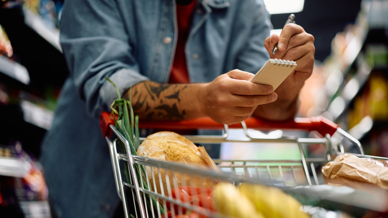 Man with shopping list in grocery store