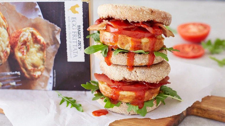 Trader Joe's Egg Frittatas layered with bacon, sauce, greens, and English muffins.