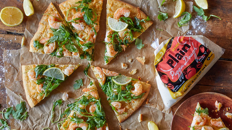 Pizza slices sit near a bag of Trader Joe's Plain Pizza Dough