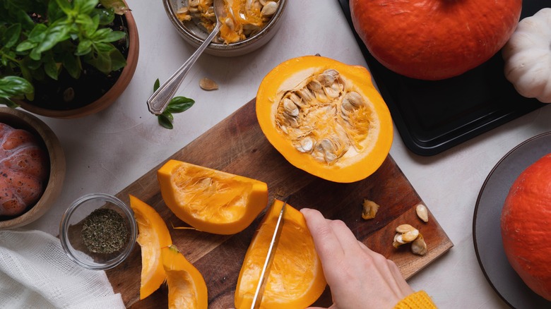 person cutting squash