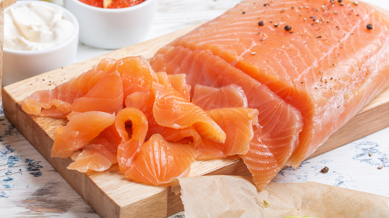 sliced smoked salmon on board