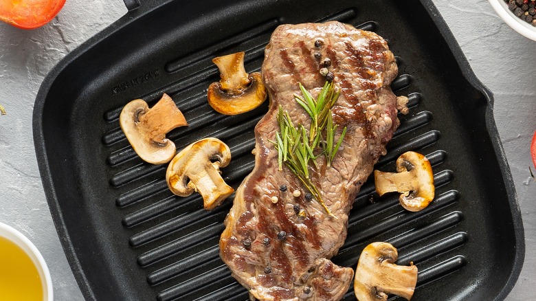steak and mushrooms in pan