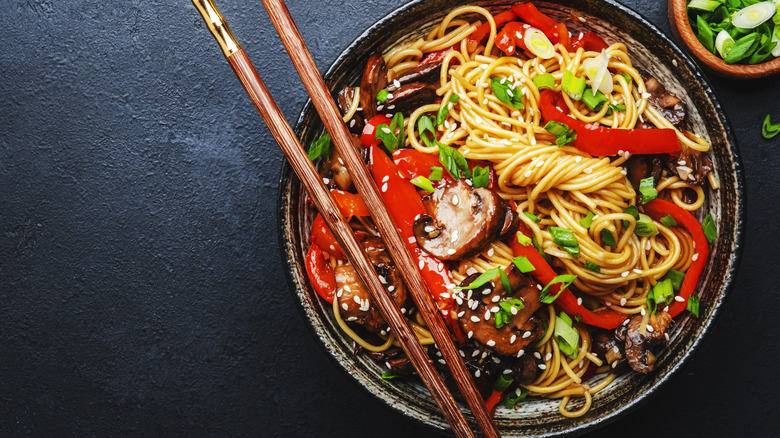 Chili oil noodles in a dark bowl 
