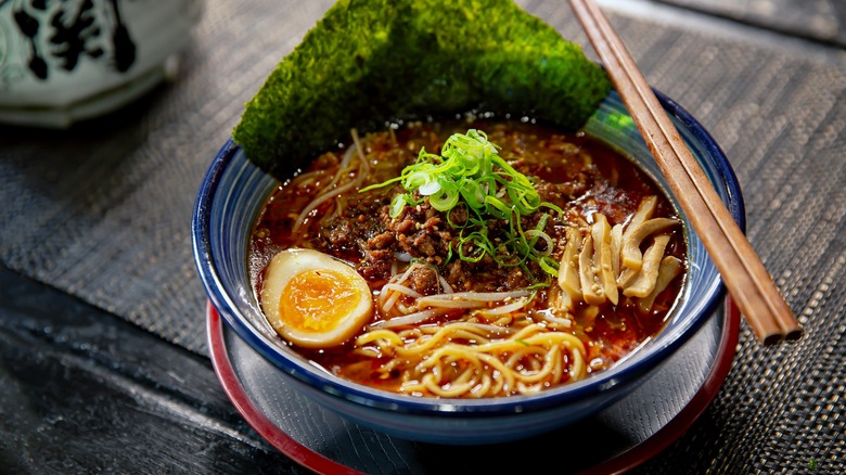 rich noodle soup in blue bowl