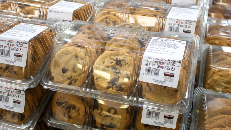Containers of Costco bakery Gourmet Chocolate Chunk Cookies are stacked.