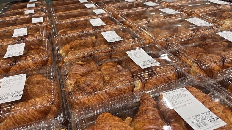 Packages of Costco bakery croissants are on display in a store.