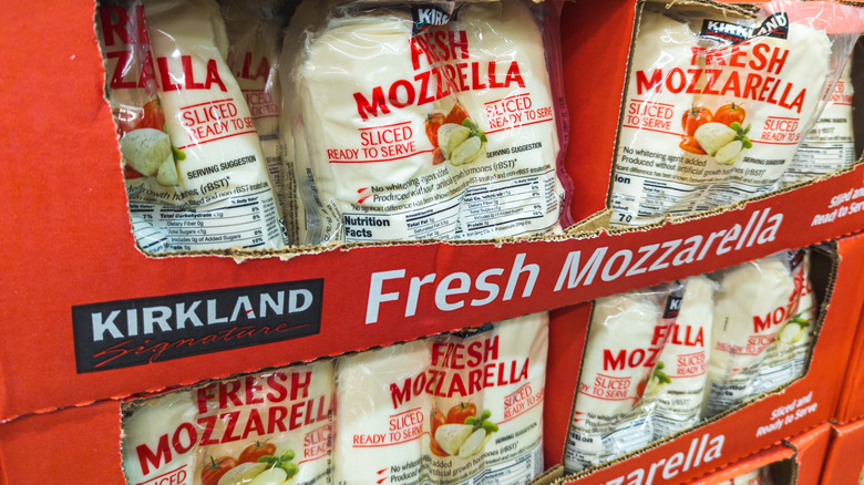 Display of Kirkland Signature Fresh Mozzarella is in a fridge.