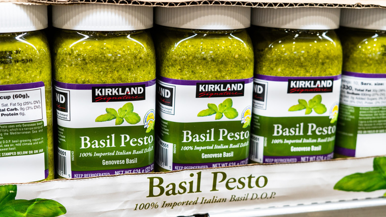 Jars of Kirkland Signature Imported Basil Pesto are on display in store.