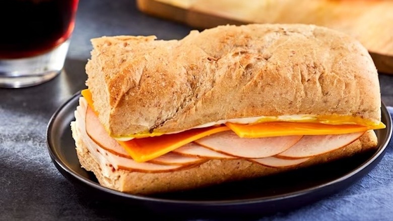 Half a Marketside Turkey and Cheddar Sub Sandwich sitting on a small plate.