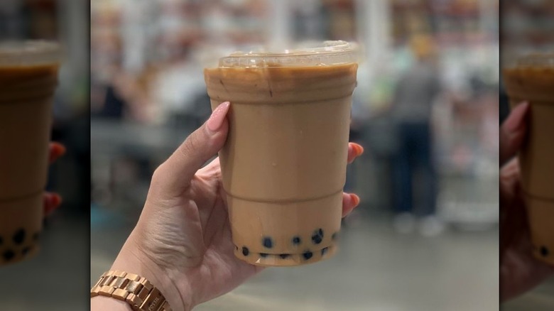 Hand holding a Costco Australia food court bubble tea.