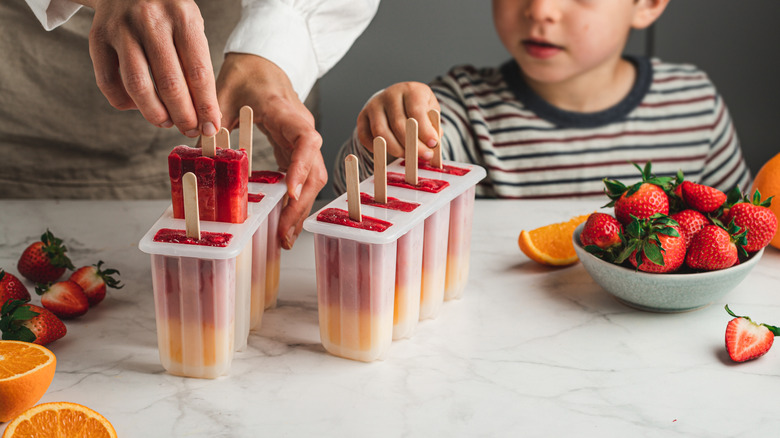 Parent and child making popsicles
