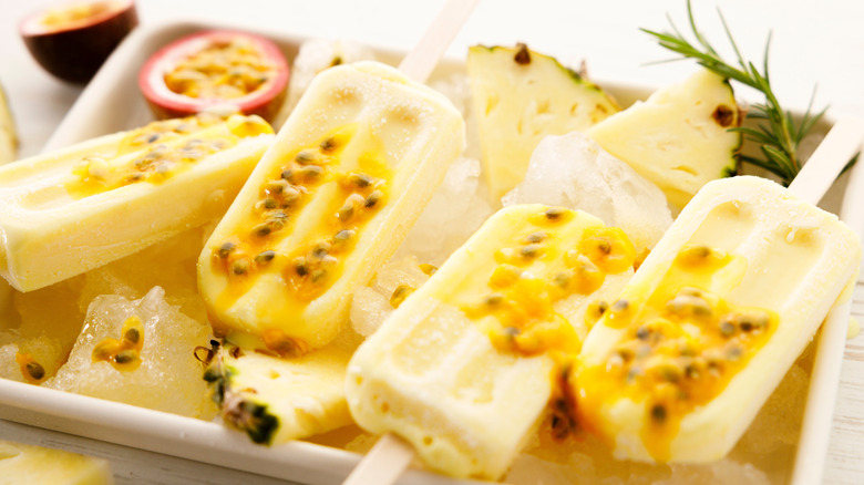 Pineapple popsicles topped with passion fruit