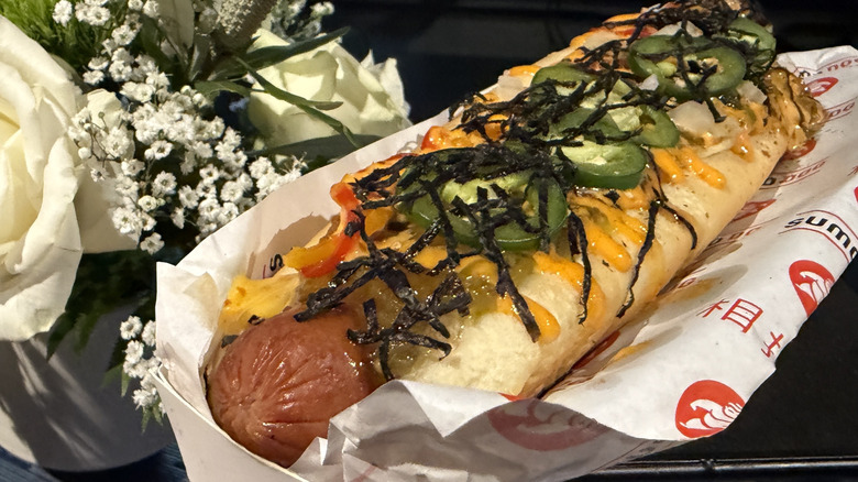 A Godzilla Dog from T-Mobile Park sits on a wrapper.