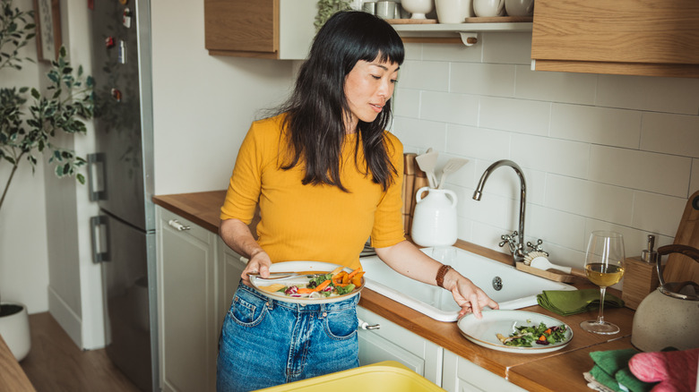 a host cleaning dinner plates after a party