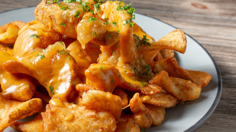 Plate of sidewinder fries with cheese sauce