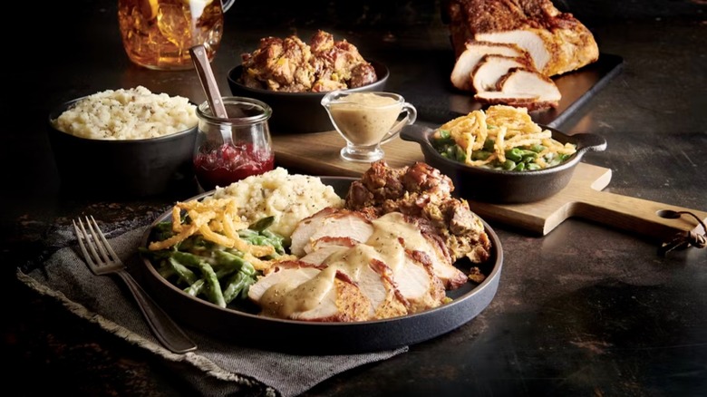 Plate of Saltgrass Steakhouse's Thanksgiving meal arranged in front of sides