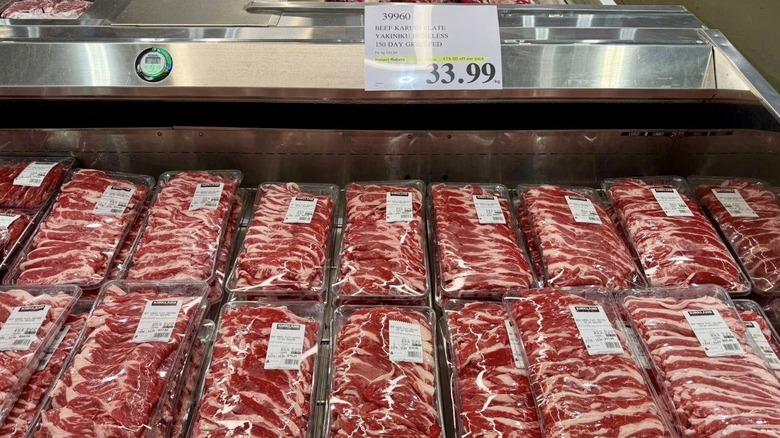 Meat sits packaged uniformly in a cooler at a Costco.