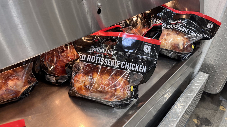 a bagged rotisserie chicken in the warmer at Costco