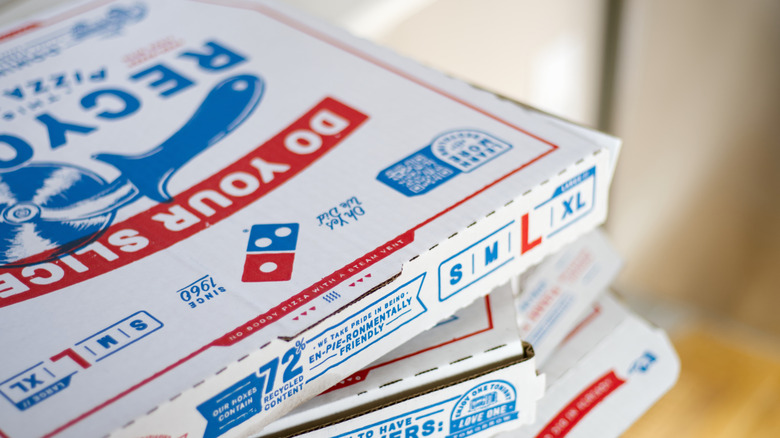 Stacked boxes of Domino's pizza.