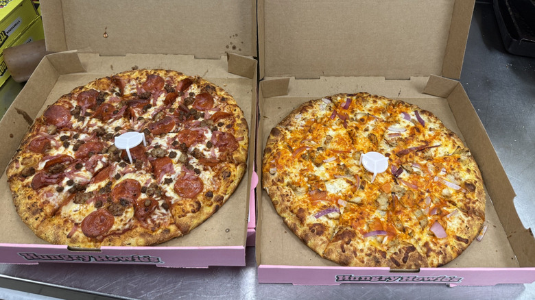 Two Hungry Howie's pizzas displayed in pizza boxes.