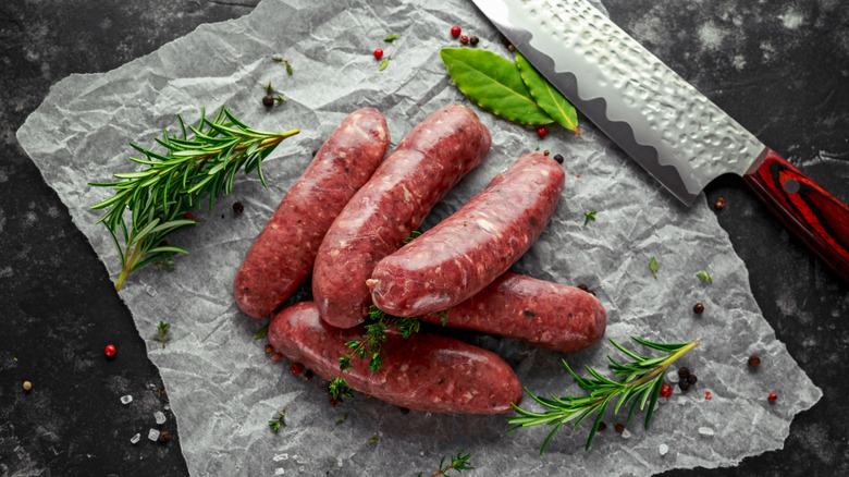 five freshly made sausages on baking paper