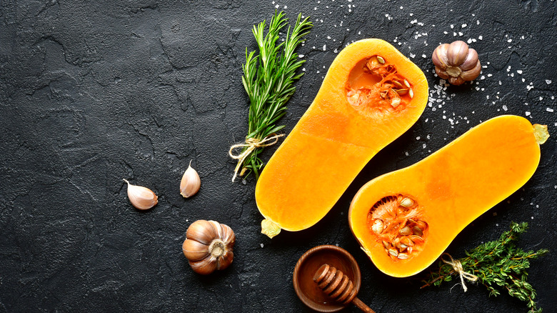 butternut squash halves on black slate