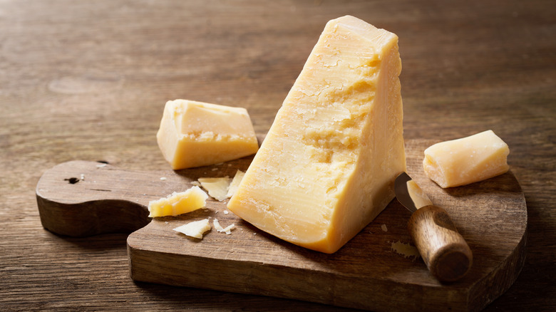 fresh parmesan cheese on wooden board
