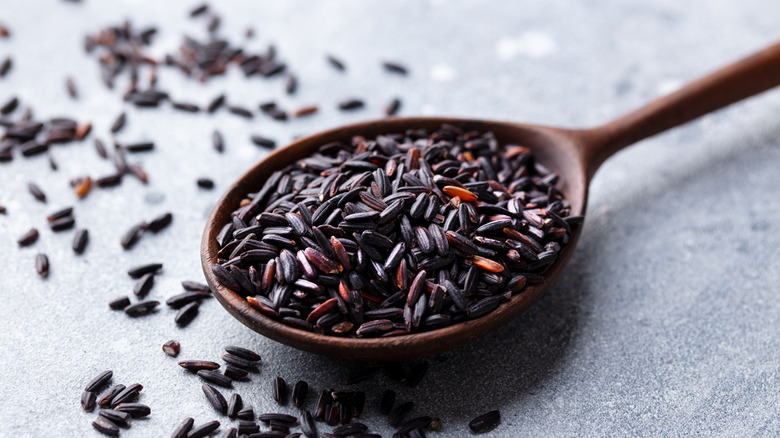 black wild rice on wooden spoon