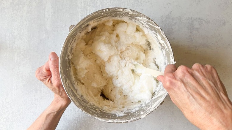 Folding beaten egg whites into vanilla cake batter