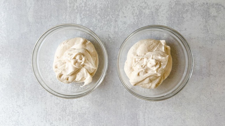 2 glass bowls filled with vanilla cake batter