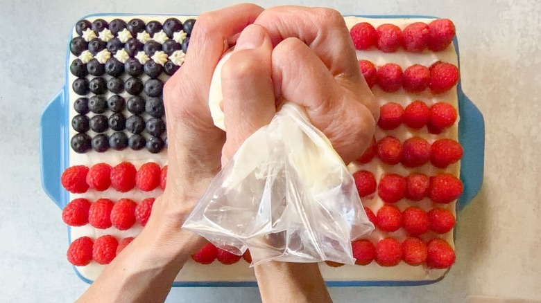 Piping icing stars onto 4th of July American flag cake