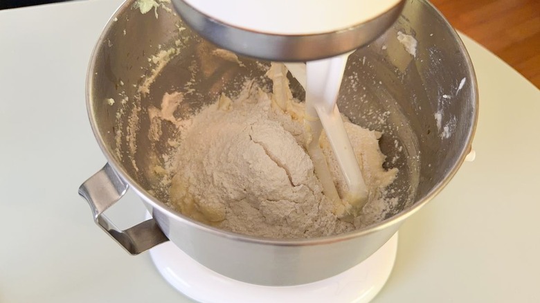 Creamed butter and sugar with dry ingredients in stand mixer bowl