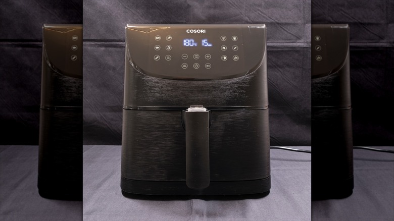 Cosori air fryer on a gray background.