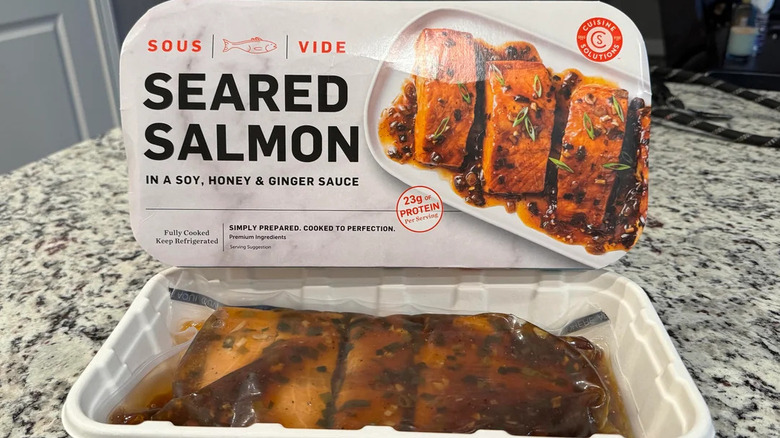 An open package of Cuisine Solutions Seared Salmon sitting on a kitchen counter.
