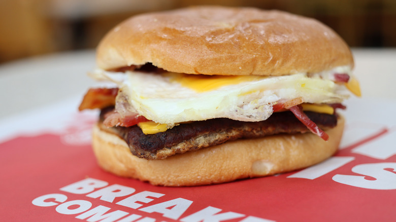 A Wendy's Breakfast Baconator sits on a paper tray liner