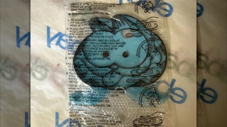 A wrapped blue Garfield bicycle reflector prize