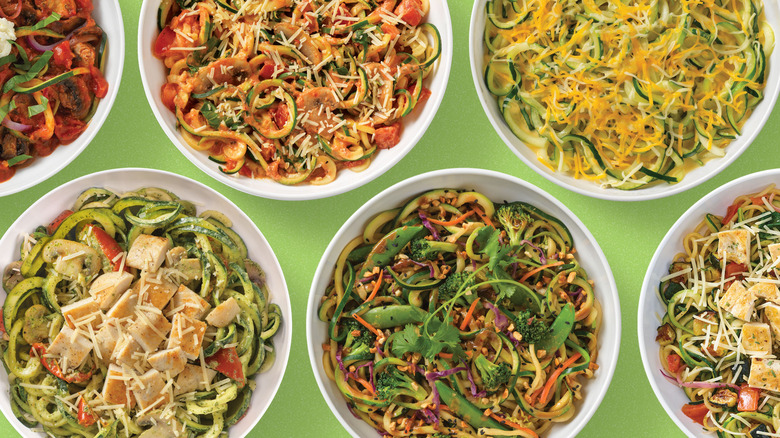 Various Noodles & Company dishes on a green background
