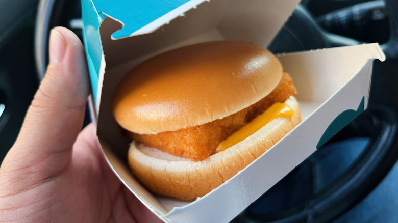 A hand holding an open Filet-O-Fish box.