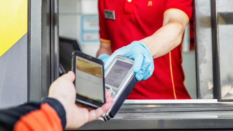 A drive-thru customer pays for McDonald's food.