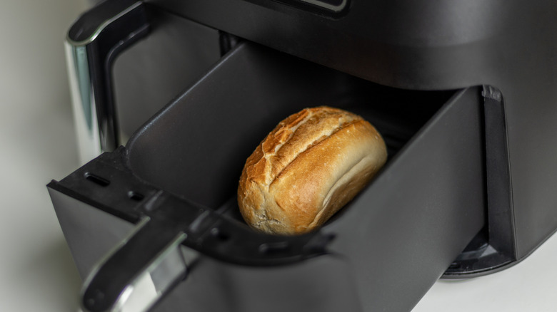 Loaf of bread in an air fryer basket.