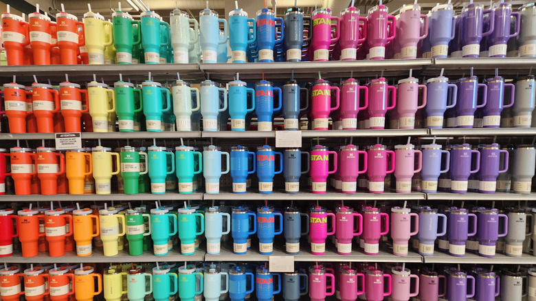 A store shelf filled with Stanley Quencher Flowstate Tumbler water bottles in a variety of colors