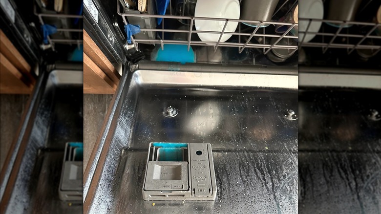 The inside of a dirty Whirlpool dishwasher