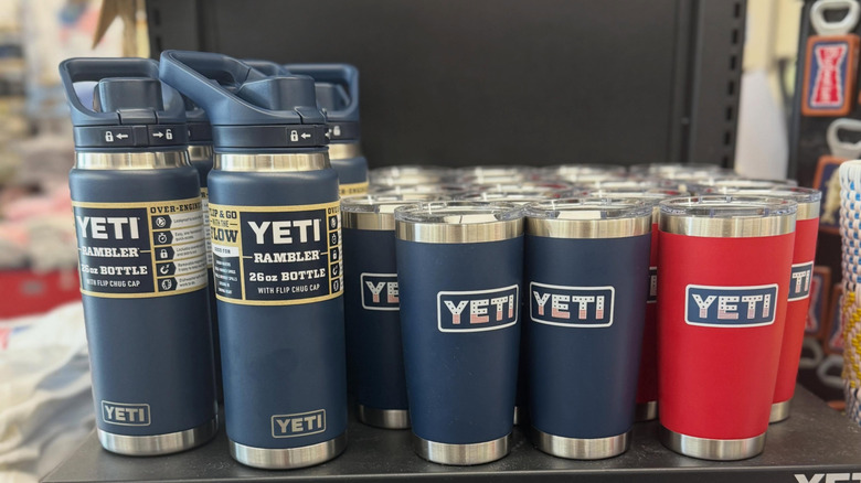 Yeti water bottles sit on a store shelf.