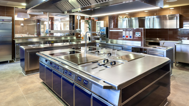 A modern industrial kitchen with stainless steel appliances