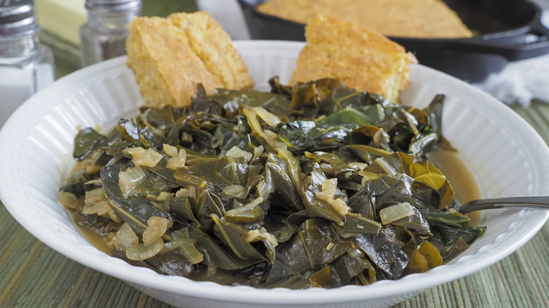 A bowl of collard greens with cornbread.