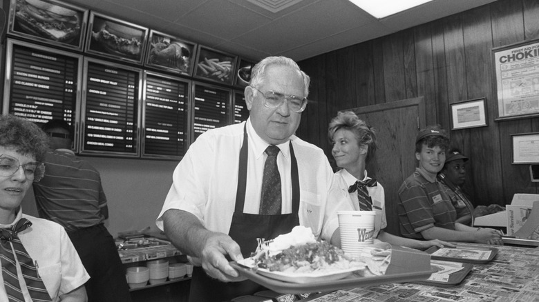 The founder of Wendy's serving food at a Wendy's restaurant