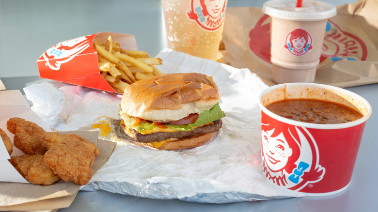 A Wendy's burger, chili, fries, chicken nuggets, and Frosty.