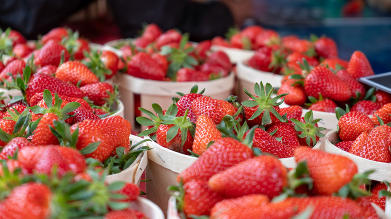 Boxes of strawberries at a market.