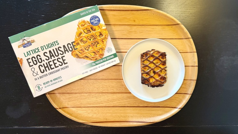 Dutchland Lattice d'Lights Egg, Sausage, and Cheese Pastry on a plate next to its packaging