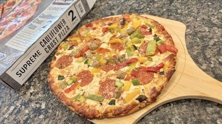 Kirkland Signature Cauliflower Pizza from costco on a wooden pizza peel